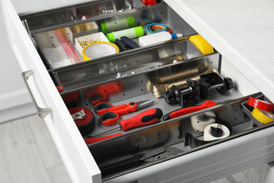 Set of instruments in open desk drawer indoors