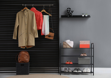 Photo of Hallway interior with stylish furniture, clothes and accessories