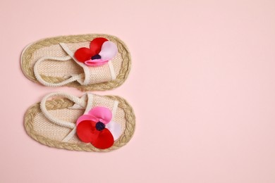 Cute baby shoes on beige background, flat lay. Space for text