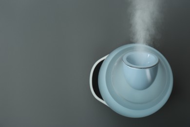 Modern air humidifier on grey background, top view. Space for text