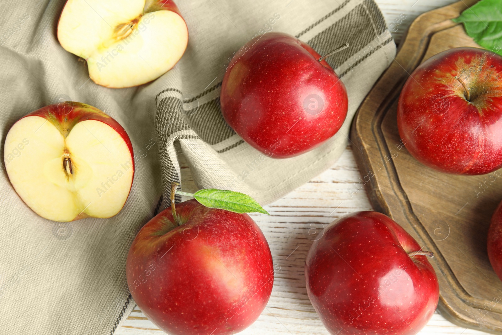 Photo of Ripe juicy red apples on white wooden background, flat lay