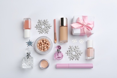 Flat lay composition with decorative cosmetic products on light background. Winter care