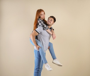 Photo of Young couple in stylish jeans on light background