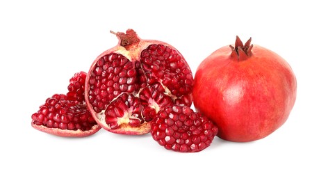 Photo of Half and whole pomegranates isolated on white