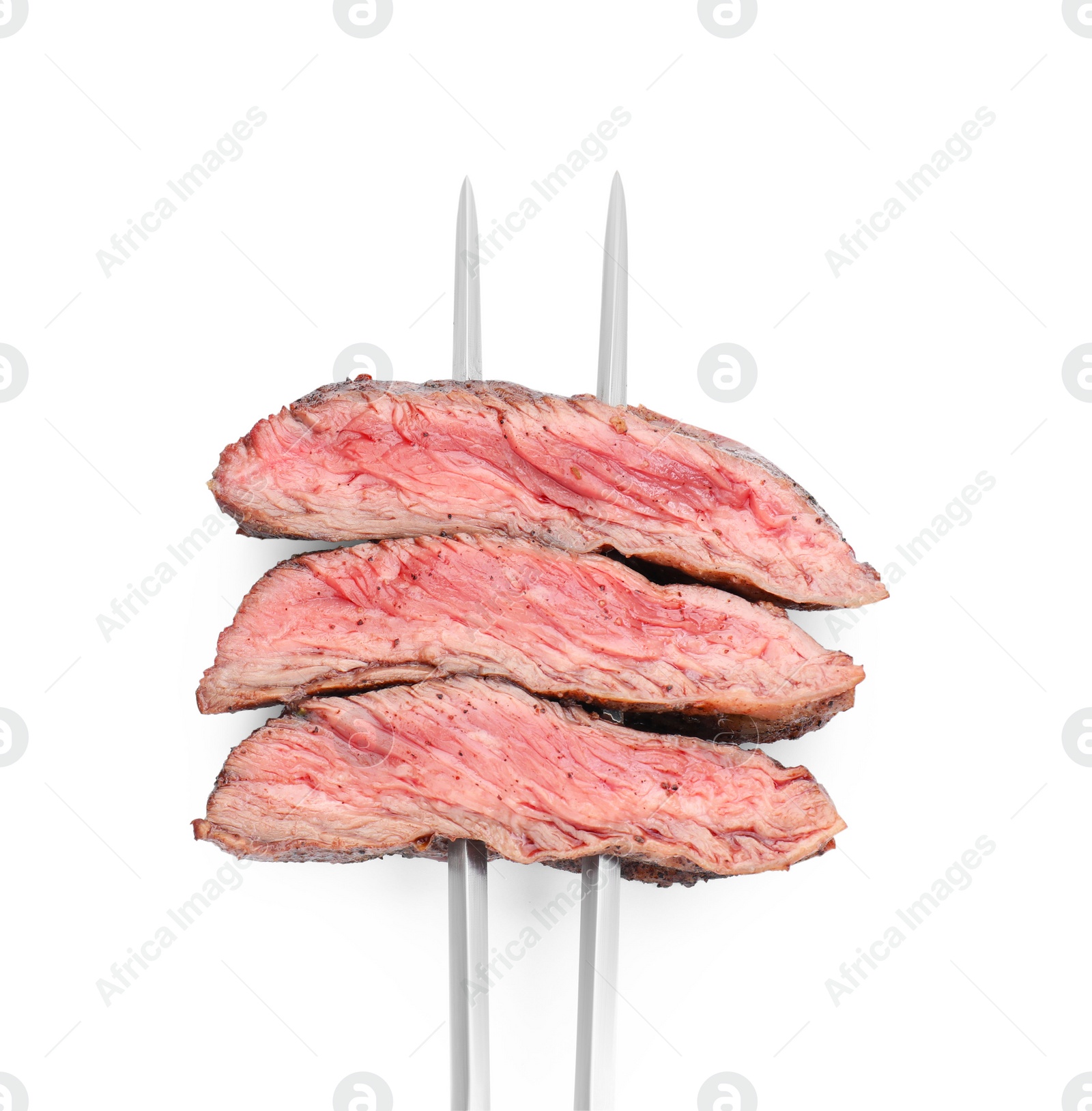 Photo of Meat fork with grilled beef pieces isolated on white, top view