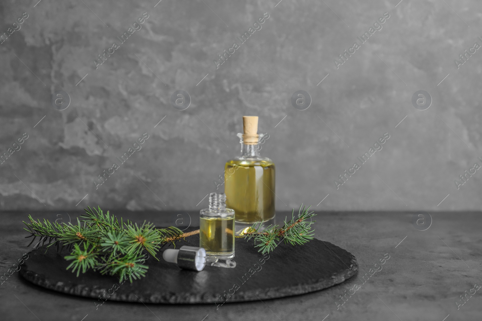 Photo of Composition with essential oil in glass bottles on table. Space for text