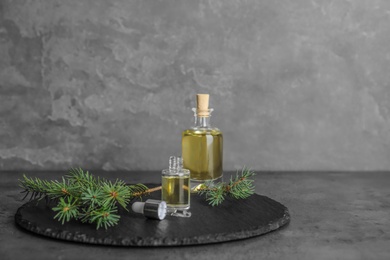 Photo of Composition with essential oil in glass bottles on table. Space for text