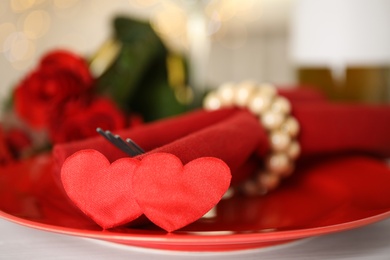 Photo of Elegant place setting for romantic dinner on white table, closeup. Valentine's day celebration