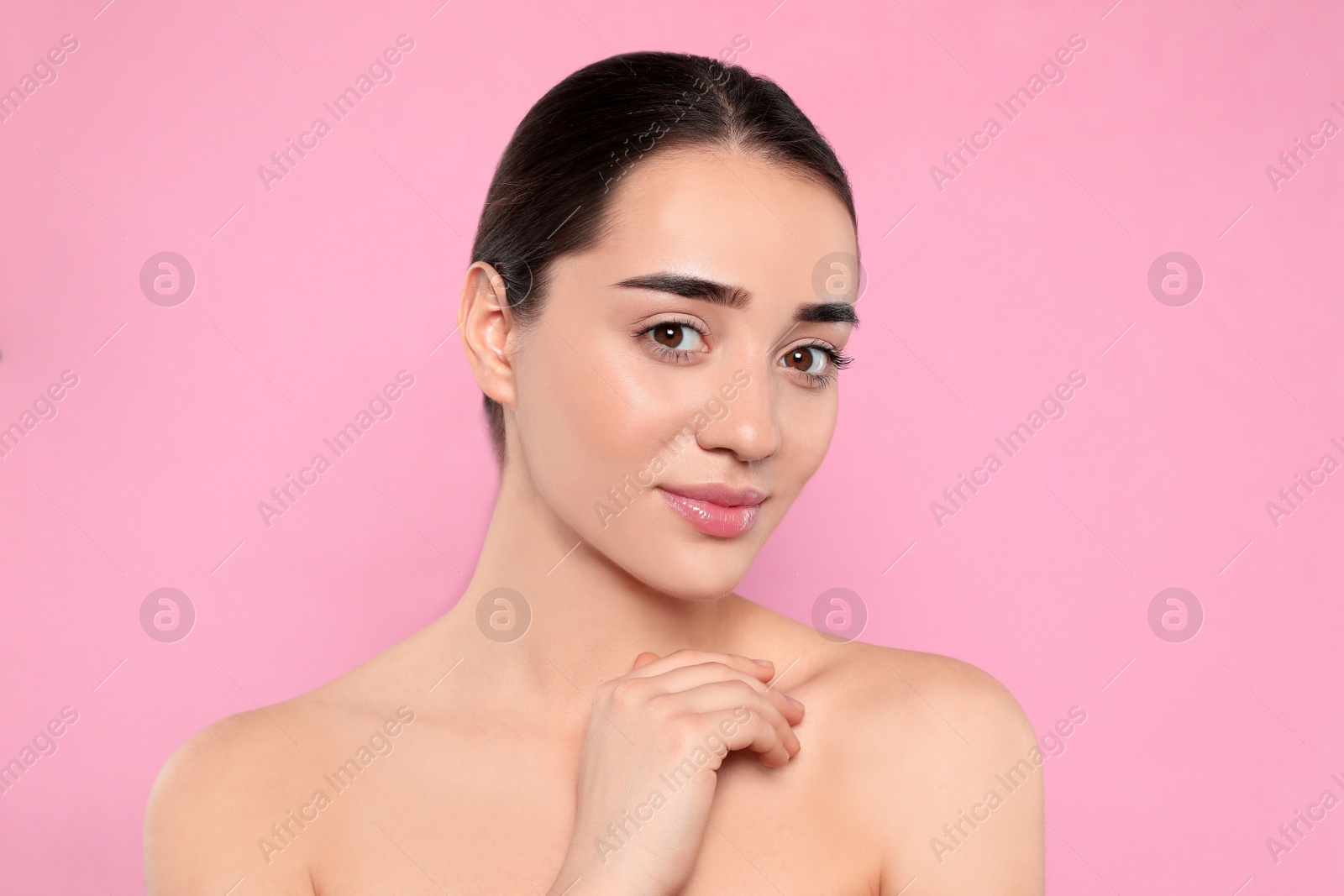 Photo of Portrait of young woman with beautiful face against color background