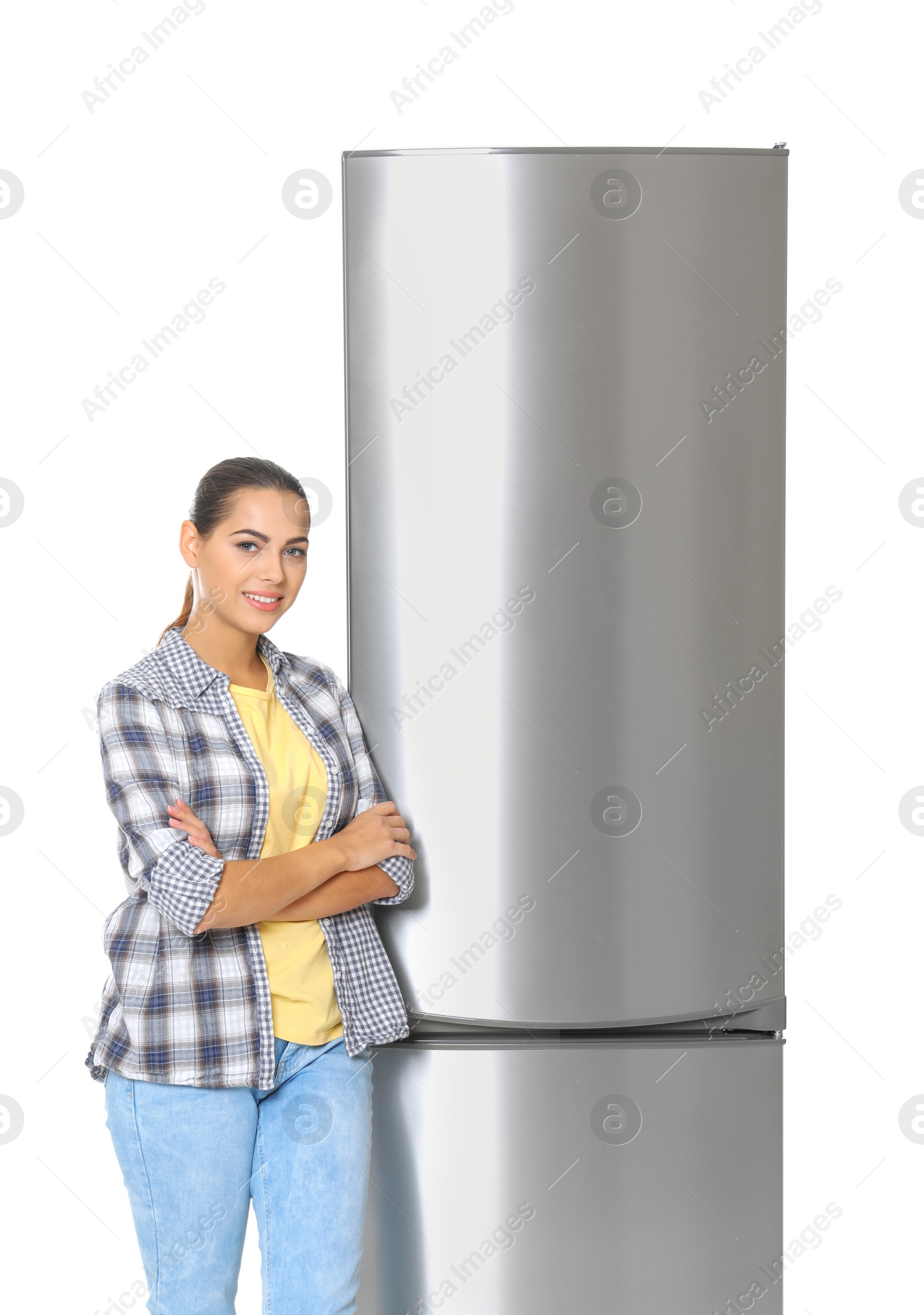 Photo of Young woman near closed refrigerator on white background