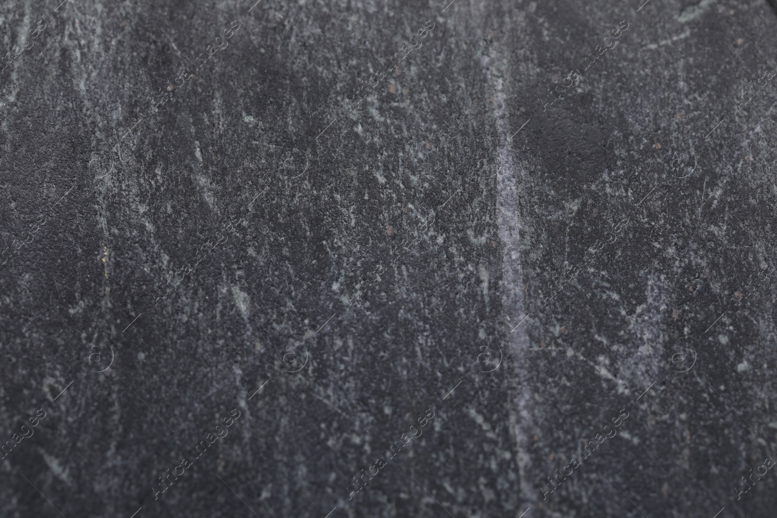 Photo of Texture of black marble surface as background, closeup