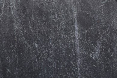 Photo of Texture of black marble surface as background, closeup