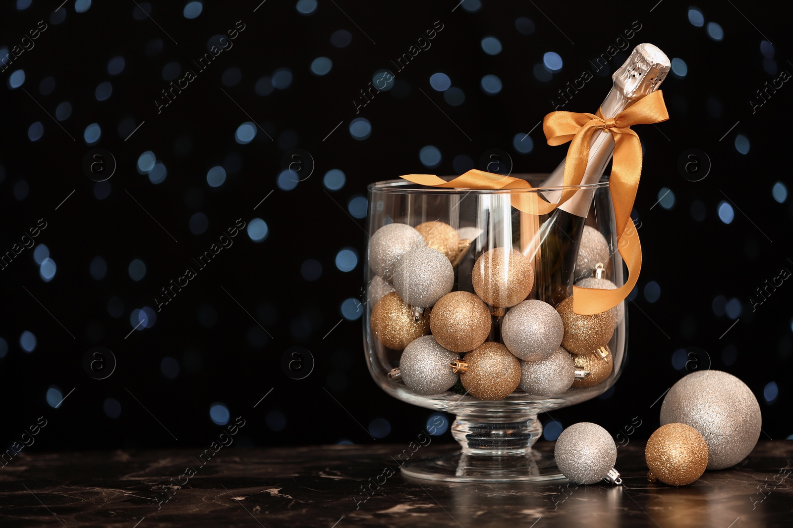 Photo of New year composition with champagne and space for text against blurred Christmas lights