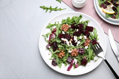 Photo of Delicious beet salad served on grey table, flat lay