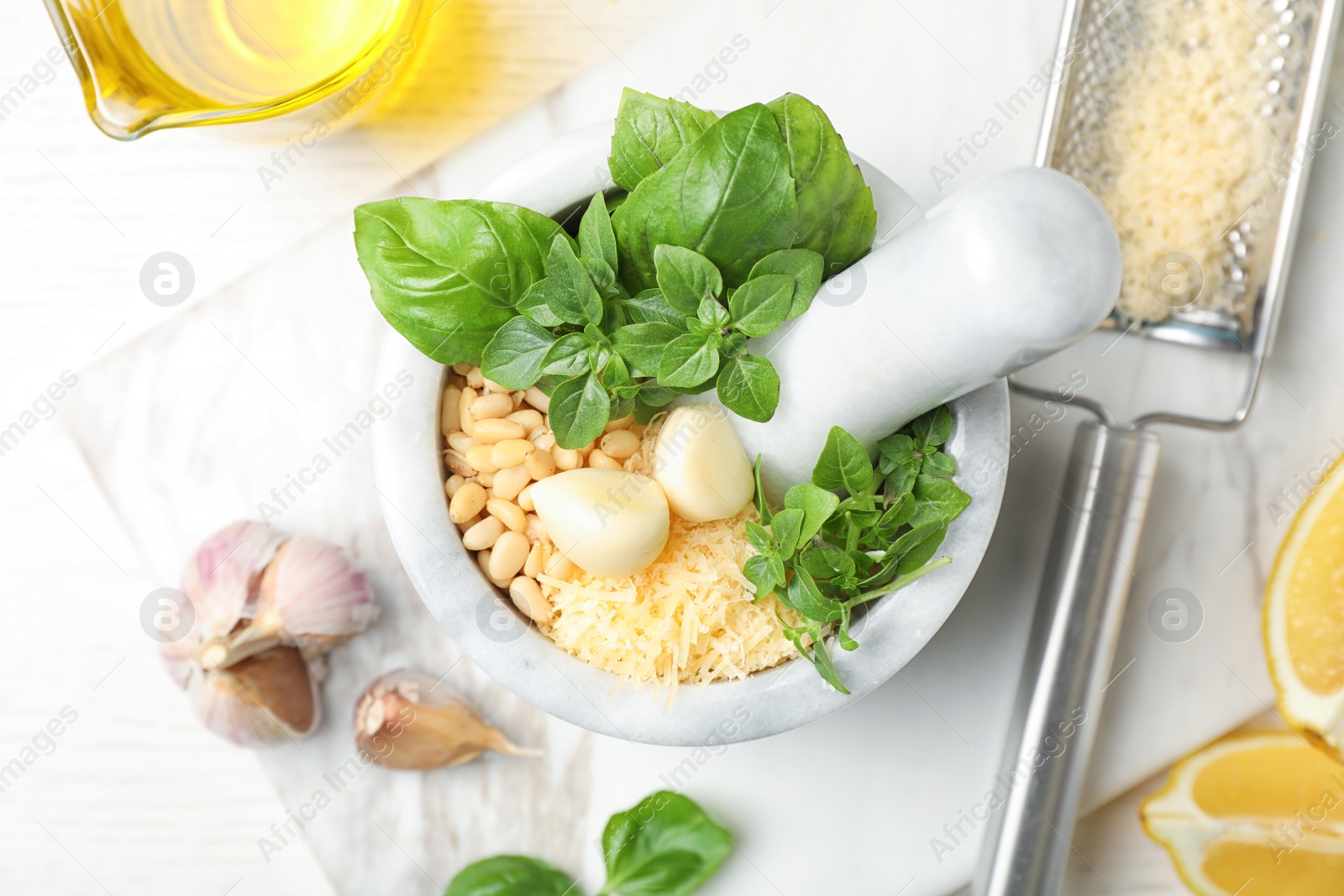 Photo of Flat lay composition with ingredients for homemade basil pesto sauce on table