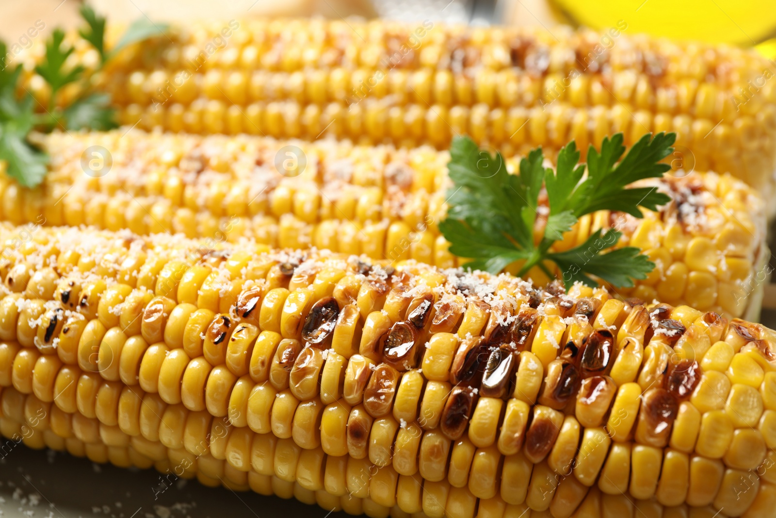 Photo of Tasty grilled corn with parmesan, closeup view