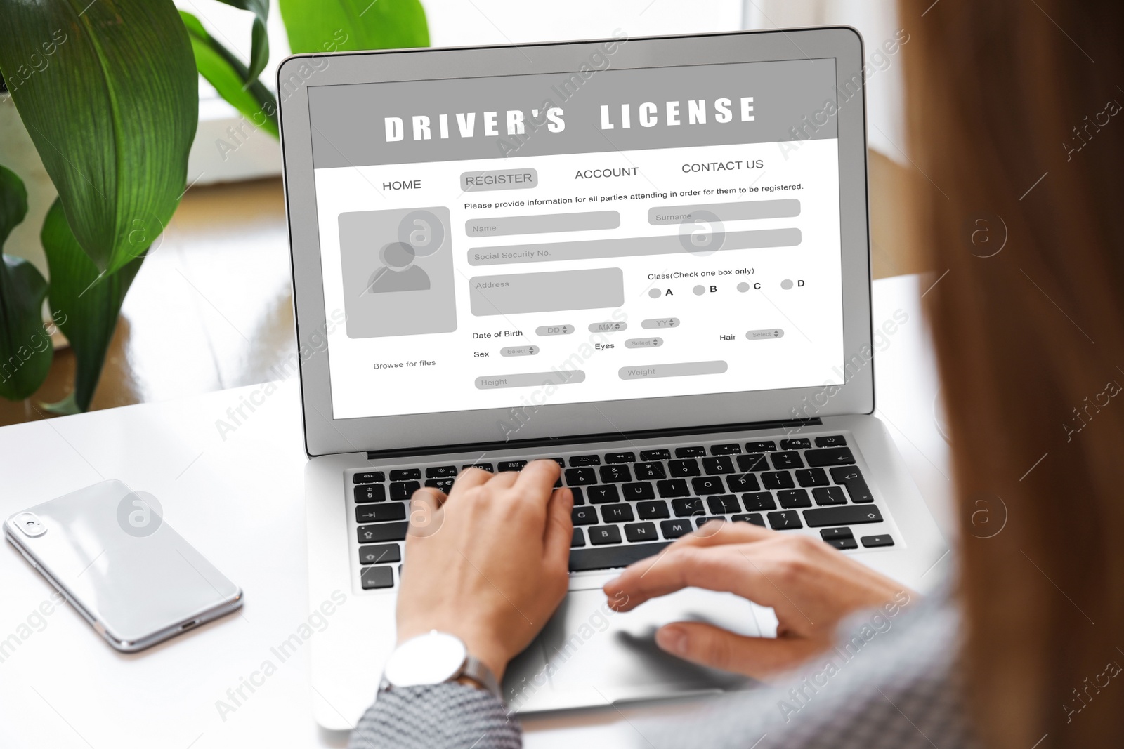 Image of Woman filling in driver's license form online on website using laptop, closeup