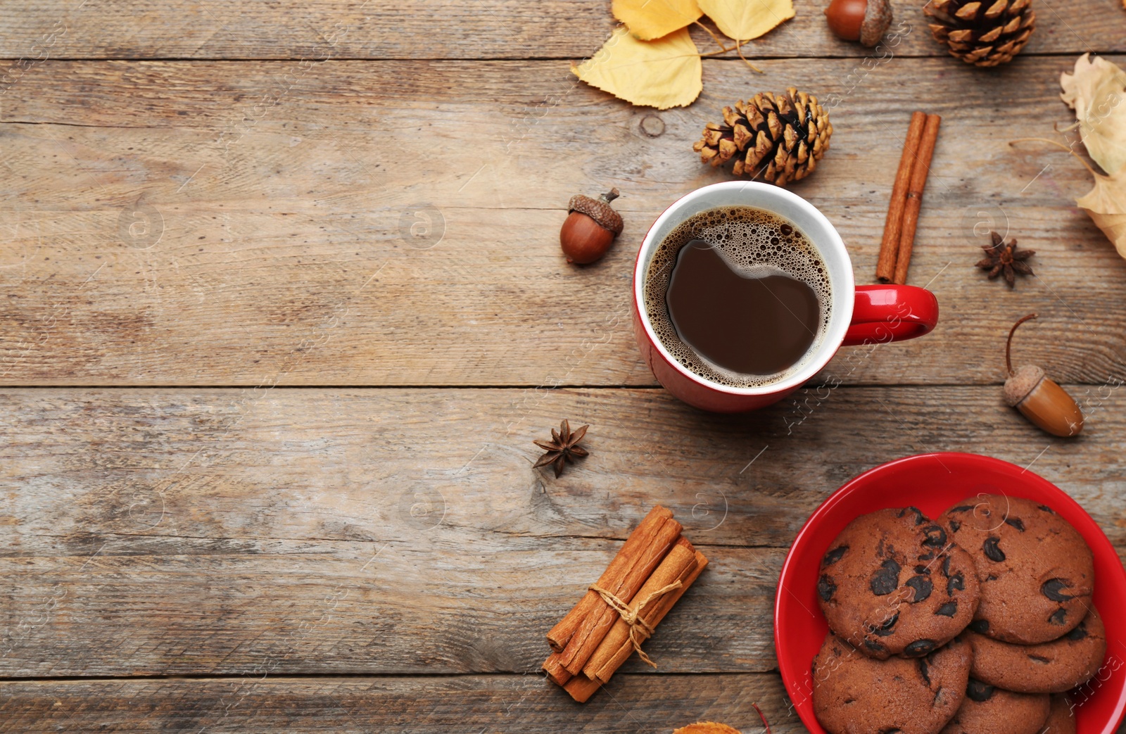 Photo of Flat lay composition with cup of hot drink on wooden table, space for text. Cozy autumn atmosphere