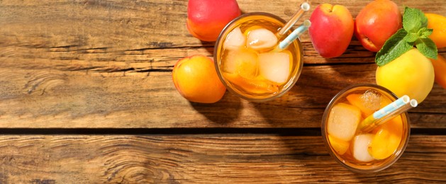 Delicious refreshing drink with apricot on wooden table, flat lay with space for text. Banner design