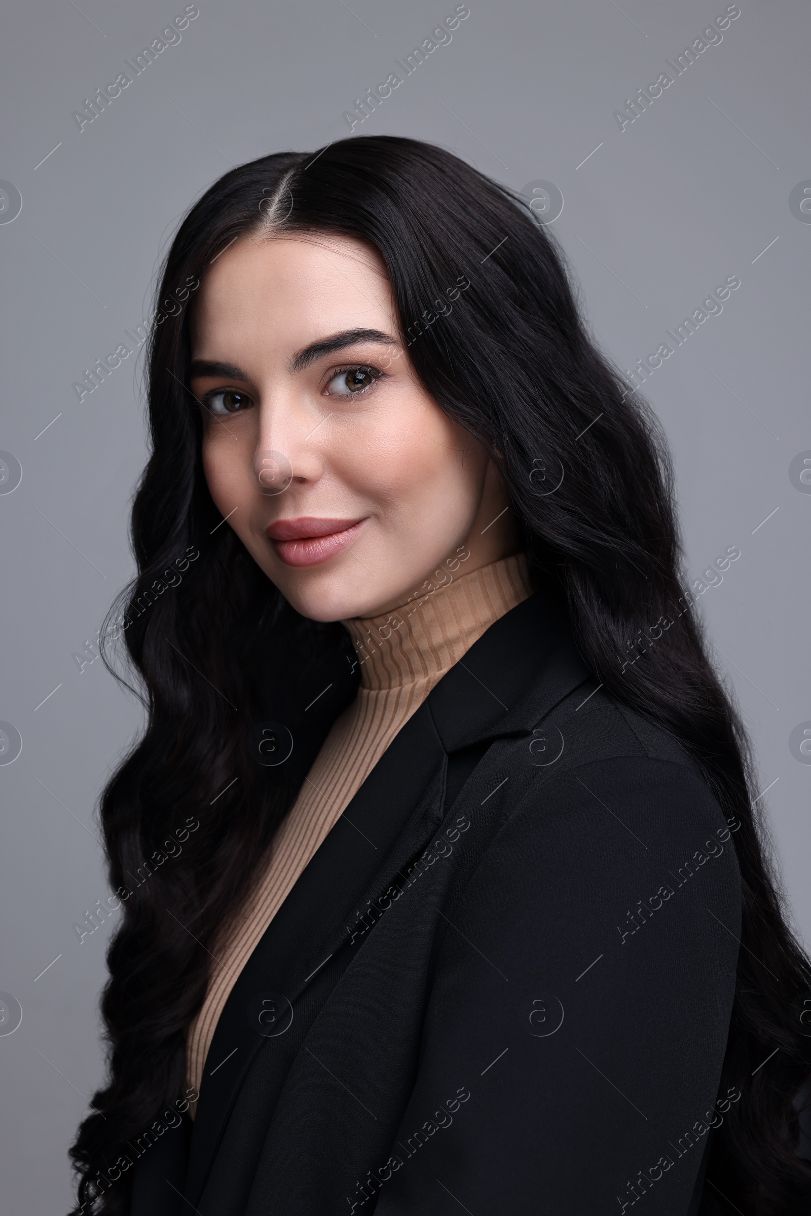 Photo of Beautiful woman in black jacket on gray background