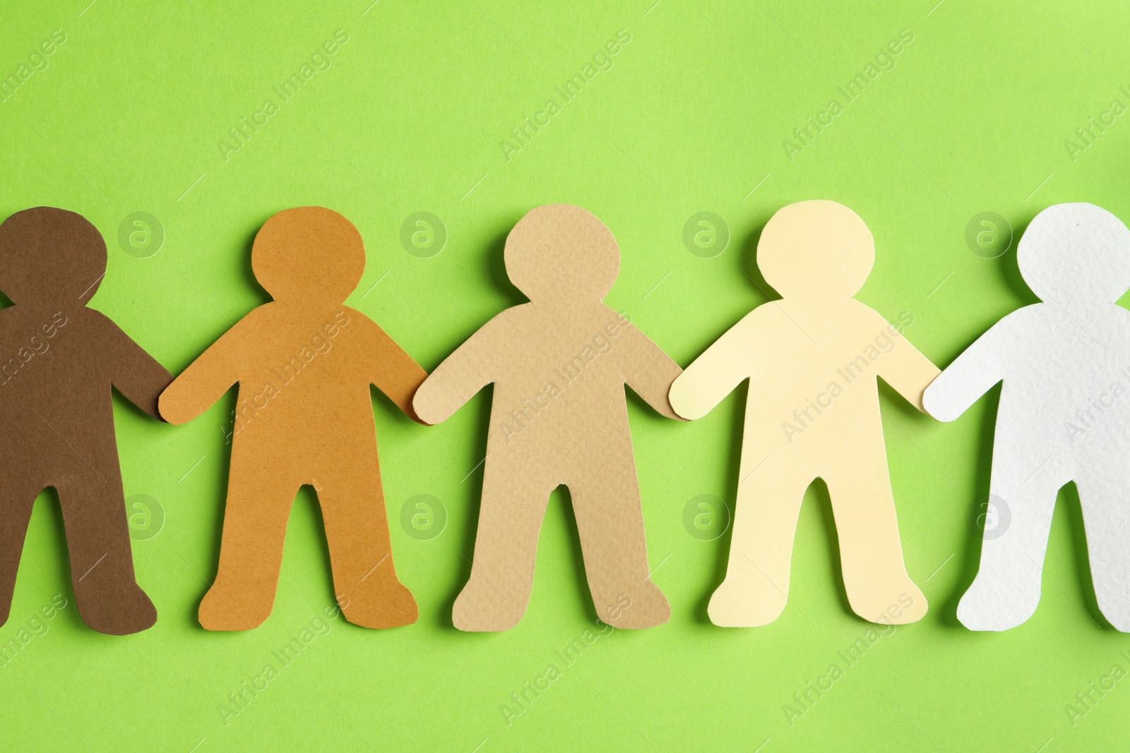 Photo of Paper people holding hands on color background, top view. Unity concept