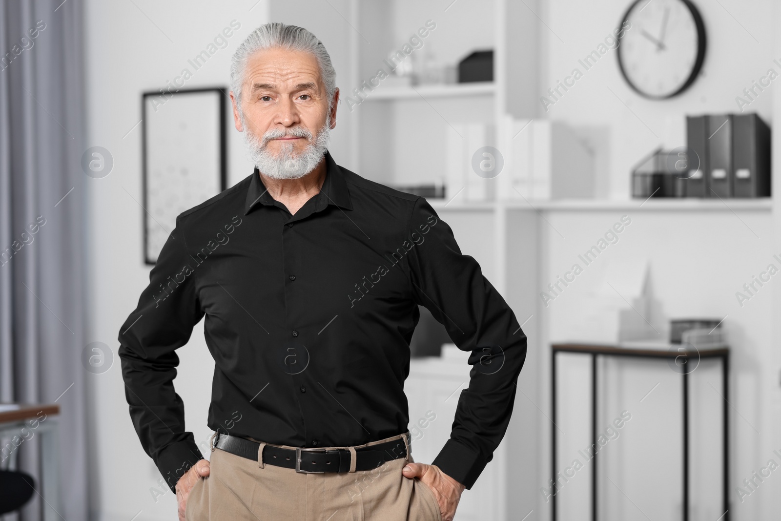 Photo of Portrait of handsome senior man in black shirt at home. Space for text