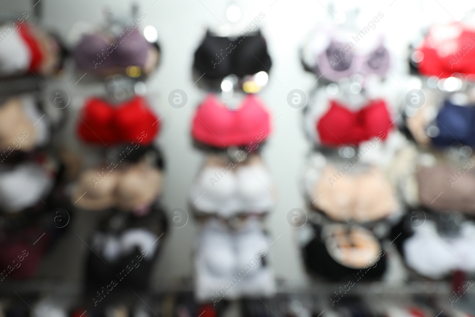 Photo of Blurred view of different underwear in boutique