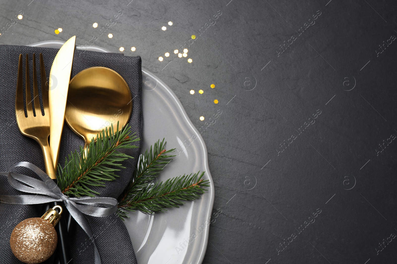 Photo of Festive table setting with beautiful dishware and Christmas decor on black background, top view. Space for text