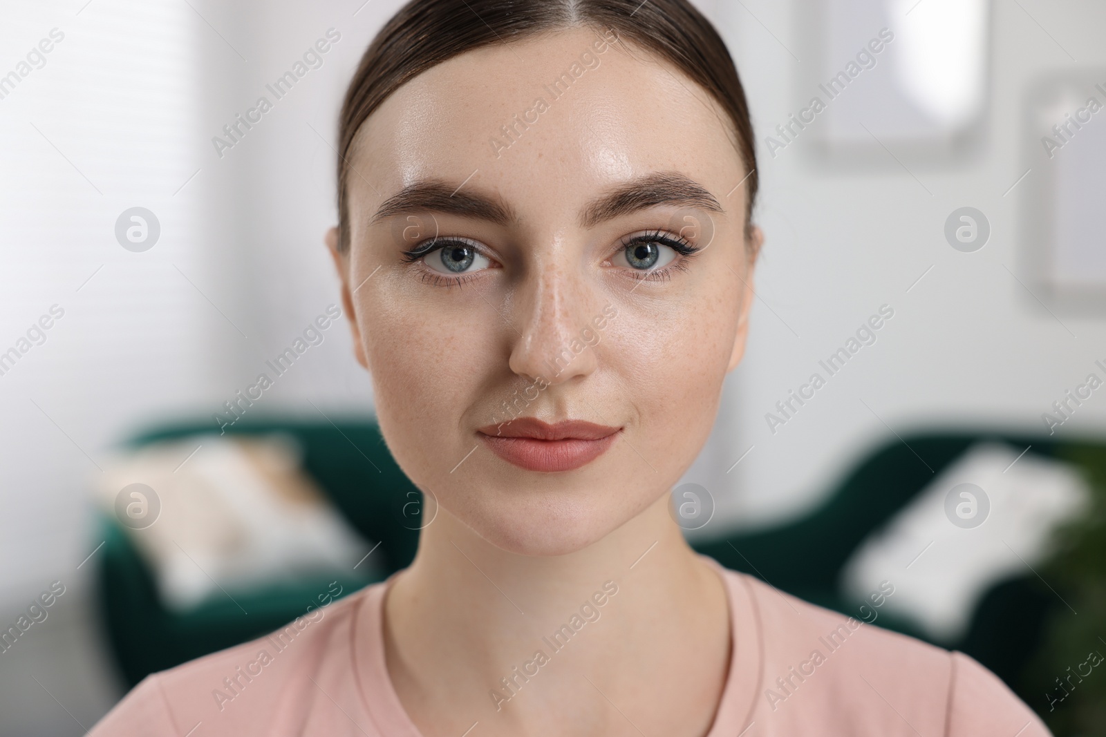 Photo of Portrait of beautiful woman looking at camera on blurred background, closeup