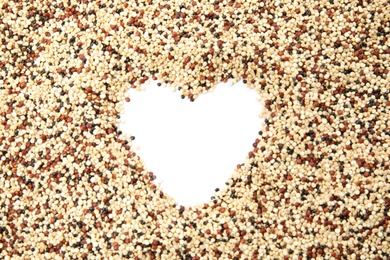 Heart shaped frame made of mixed quinoa seeds and space for text on white background, top view