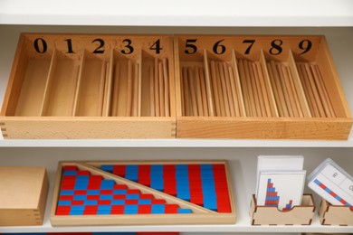 White shelving unit with different montessori toys