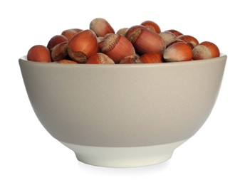 Photo of Ceramic bowl with hazelnuts isolated on white. Cooking utensil