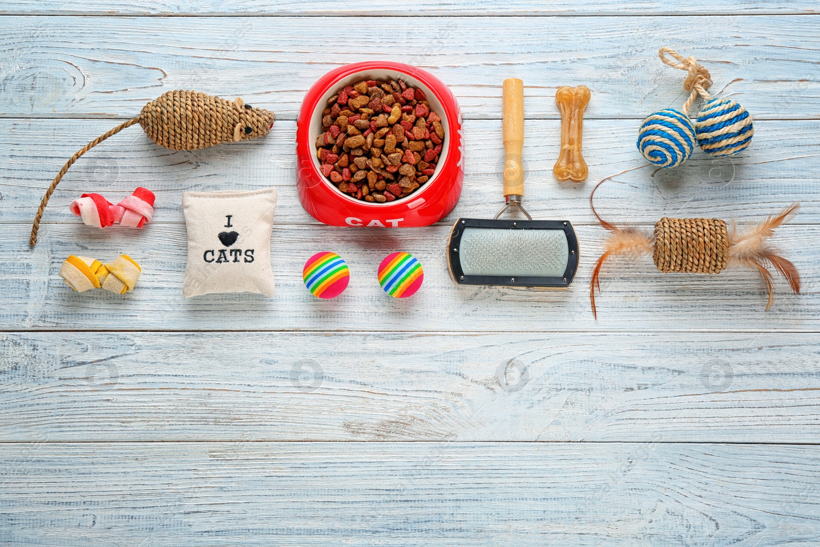 Photo of Cat's accessories and food on wooden background