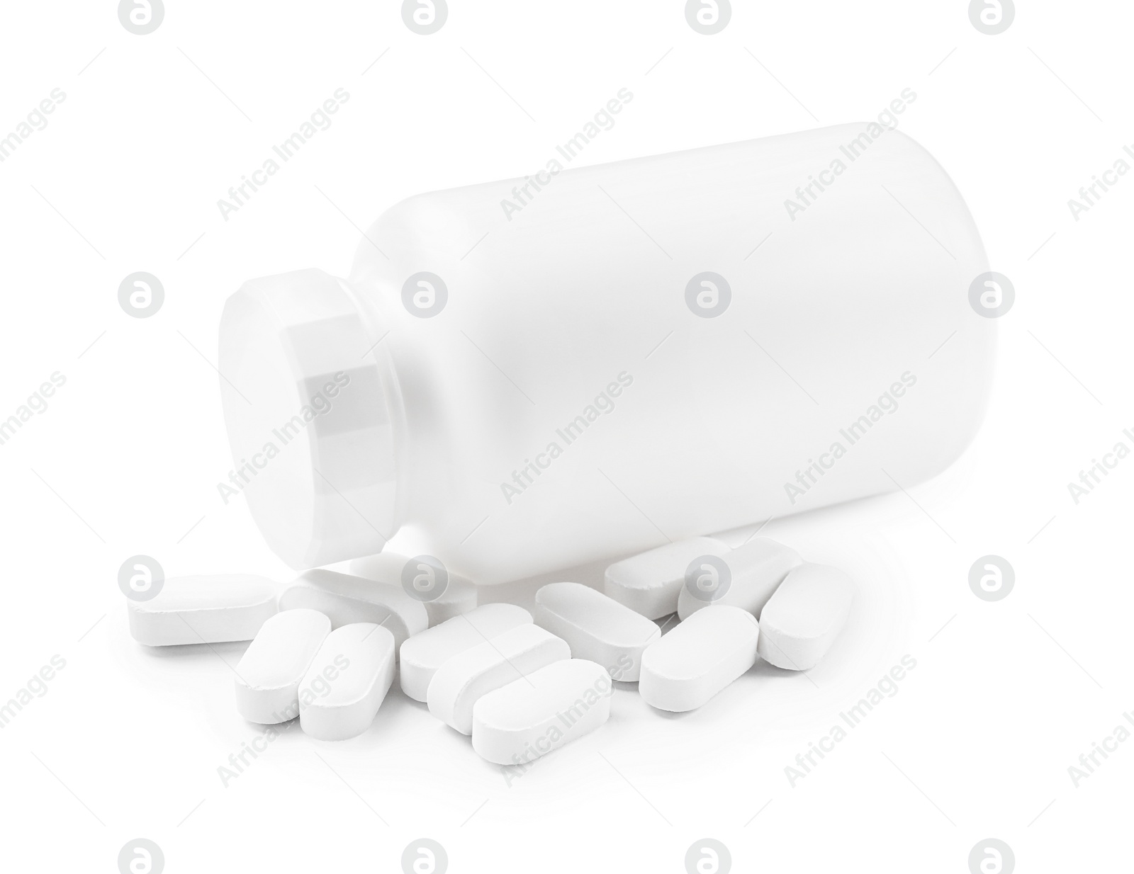 Photo of Vitamin pills and bottle isolated on white