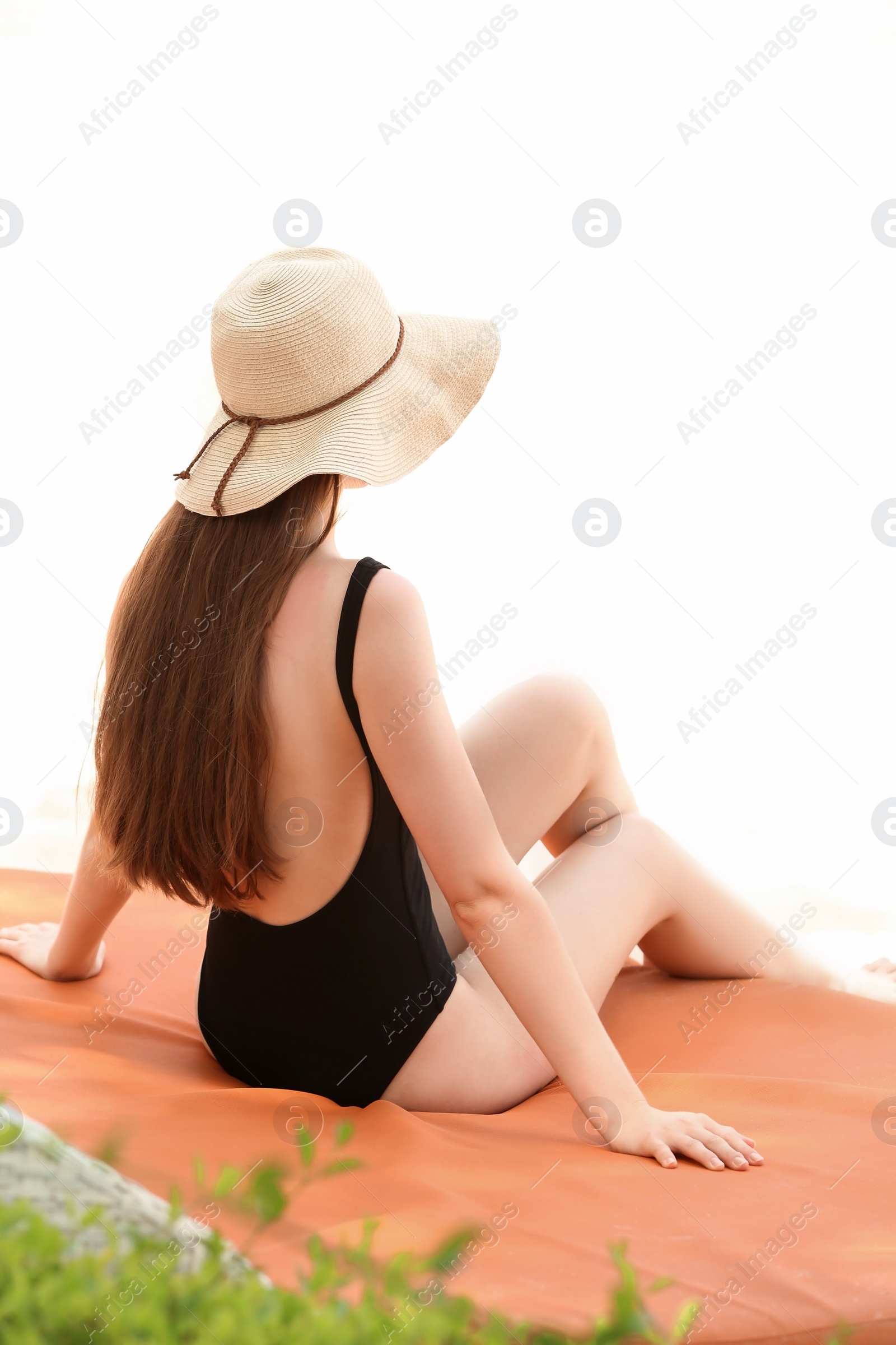 Photo of Beautiful young woman in swimsuit at resort