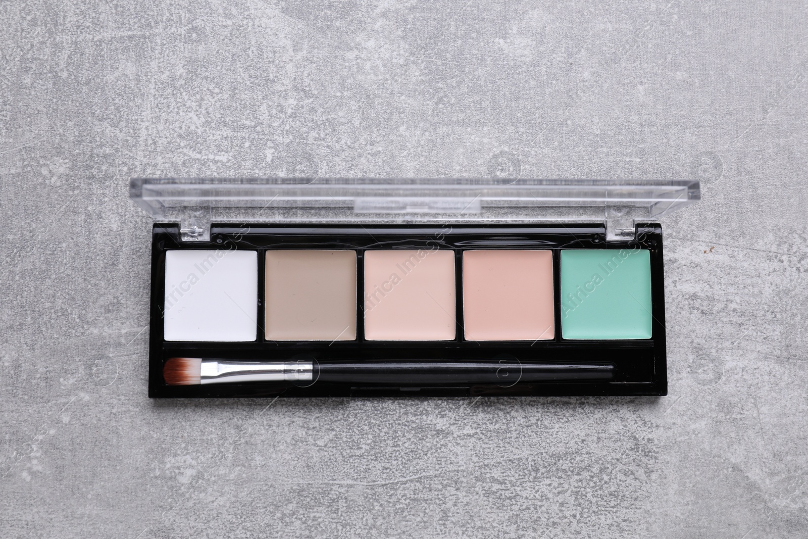 Photo of Contouring palette on light gray background, top view. Professional cosmetic product