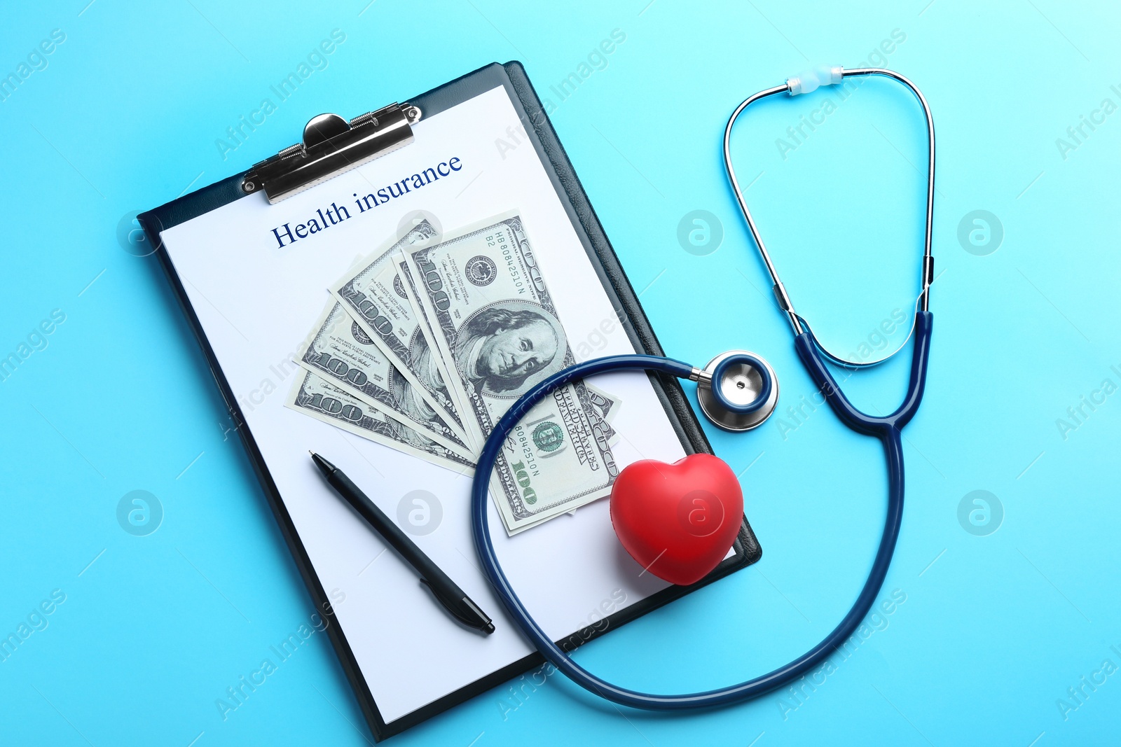 Photo of Flat lay composition with medical insurance form, money, heart and stethoscope on blue background