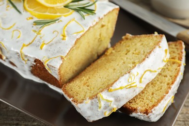 Photo of Tasty lemon cake with glaze on table, closeup