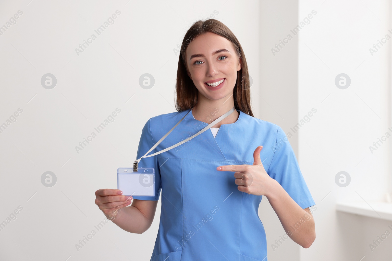 Photo of Happy doctor with blank badge in hospital