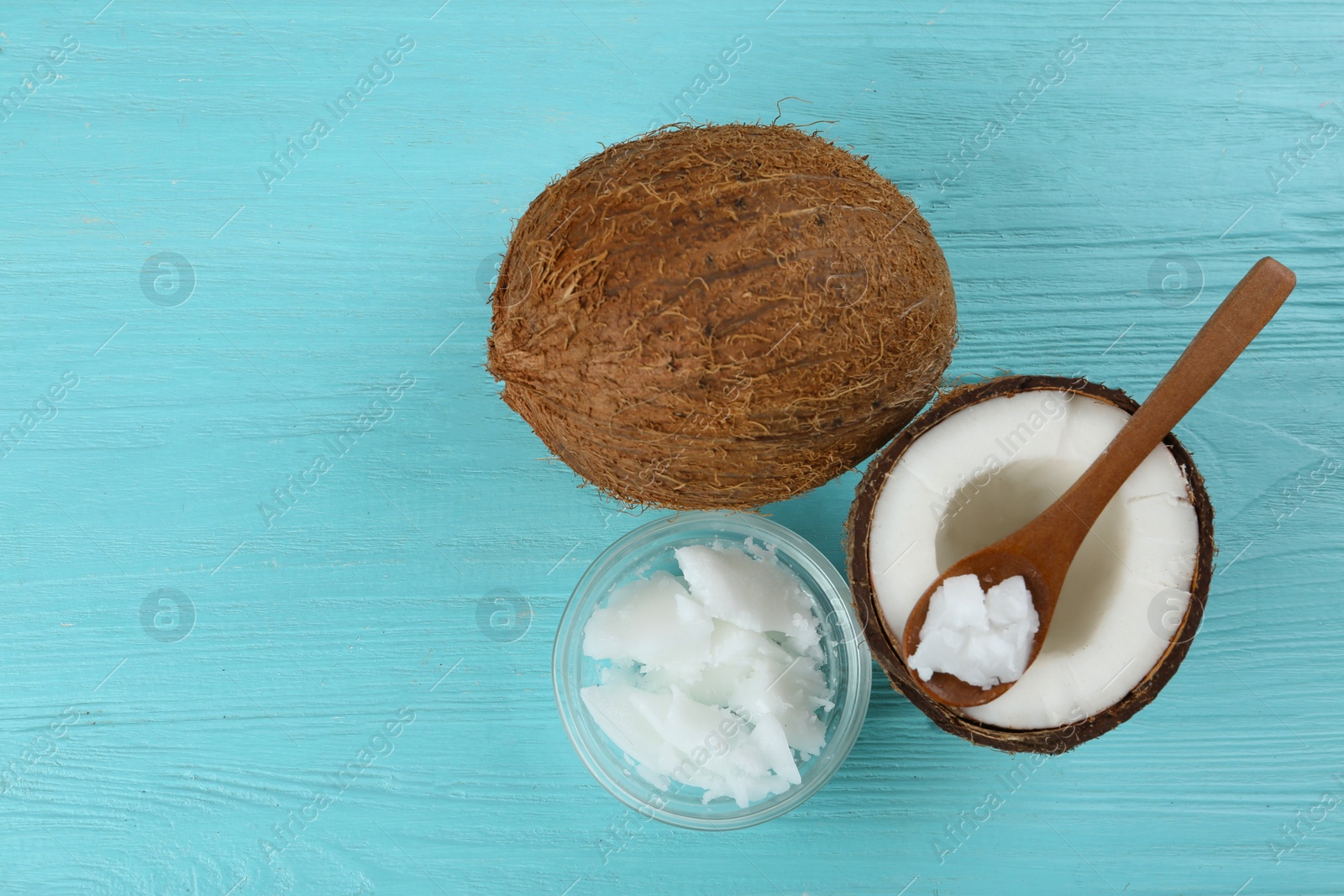 Photo of Flat lay composition with organic coconut oil on light blue wooden table. Healthy cooking