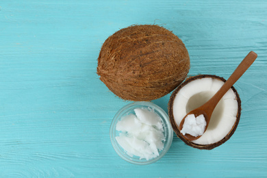 Photo of Flat lay composition with organic coconut oil on light blue wooden table. Healthy cooking