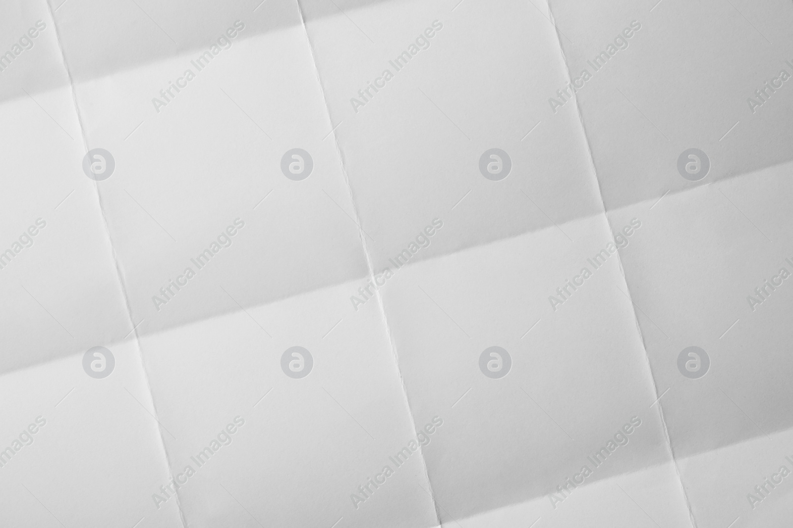 Photo of Blank sheet of paper with creases as background, closeup