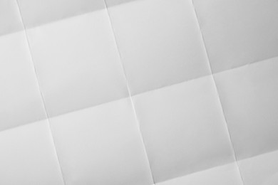 Blank sheet of paper with creases as background, closeup