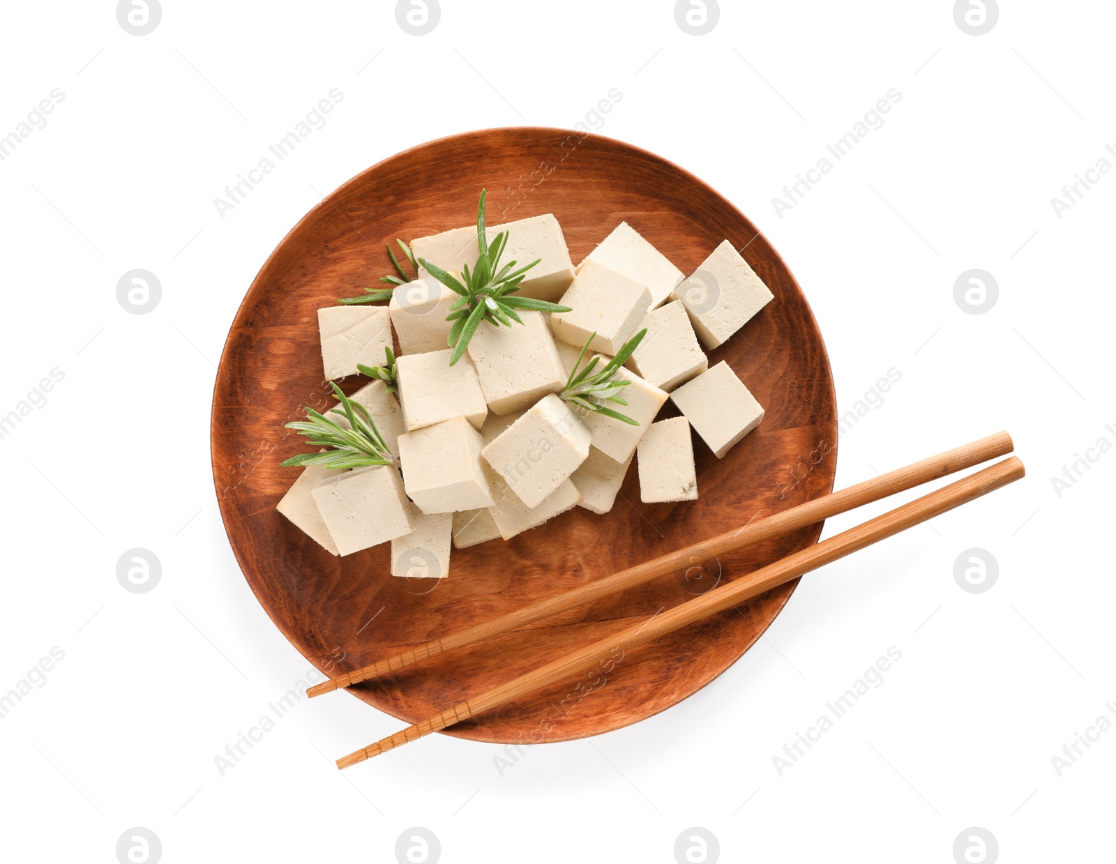 Photo of Wooden plate with delicious tofu, rosemary and chopsticks isolated on white, top view