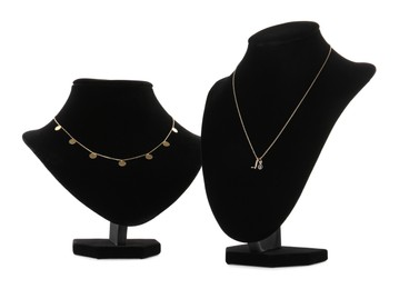 Photo of Stylish necklaces on jewelry busts against white background