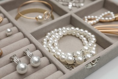 Photo of Box with luxurious pearl jewelry, closeup view