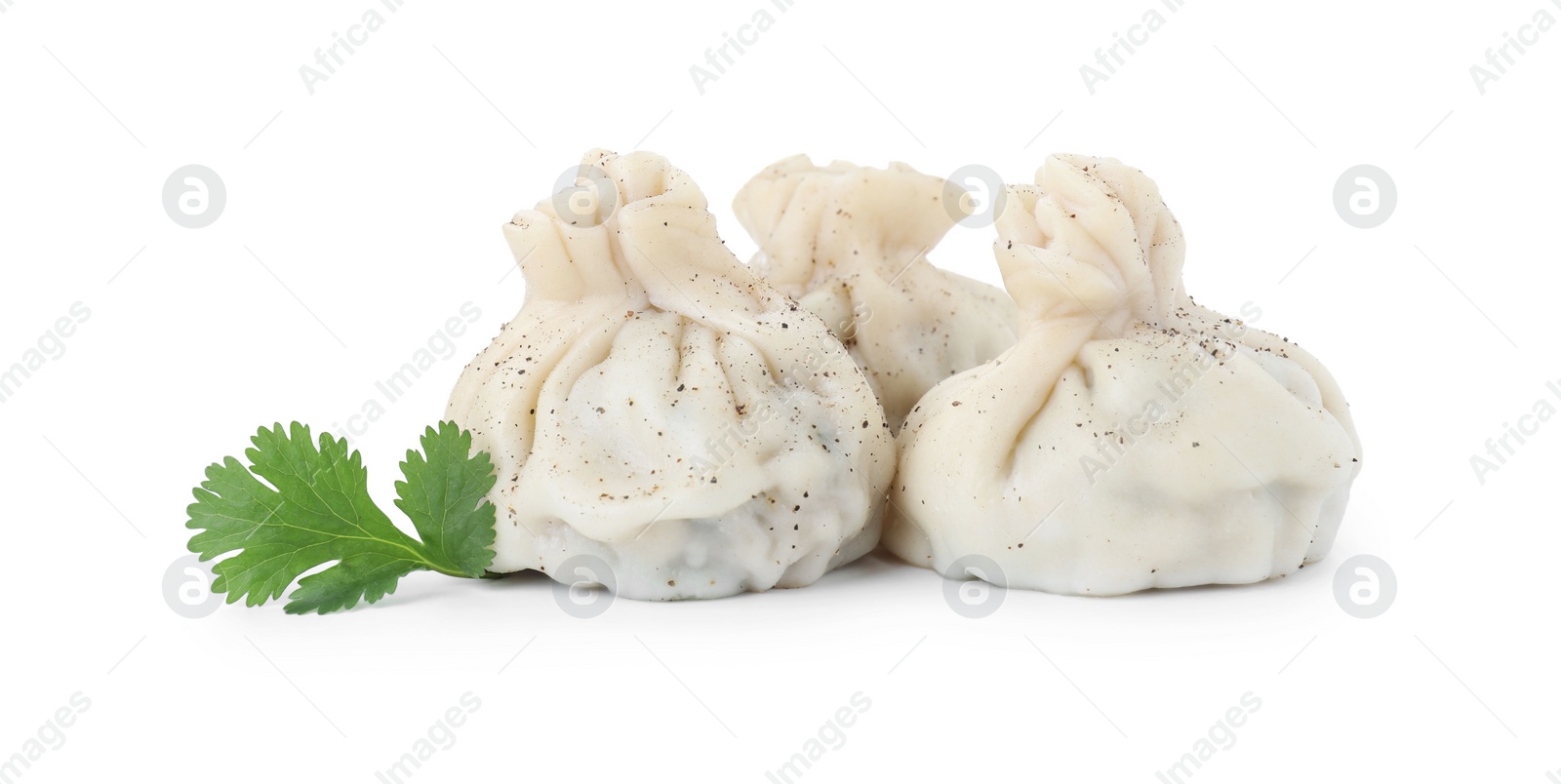 Photo of Three tasty khinkali (dumplings) and spices isolated on white. Georgian cuisine