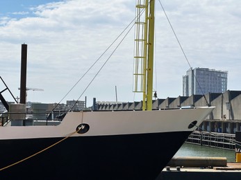 Photo of Ships moored in sea port on sunny day