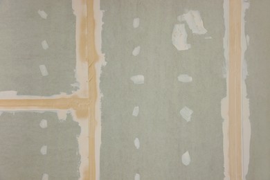 Photo of Grey drywall preparing for renovation as background