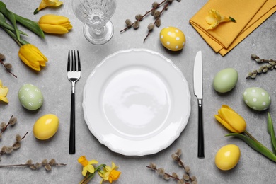 Photo of Festive Easter table setting with eggs on grey background, flat lay